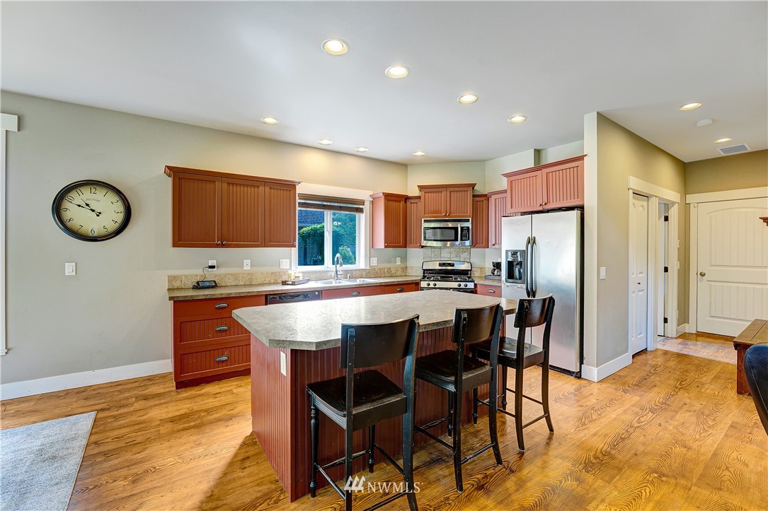 1290 West Axton Road Ferndale, WA 98248 - Photo 13 of 36 a dining hall with stainless steel appliances granite countertop a dining table and chairs