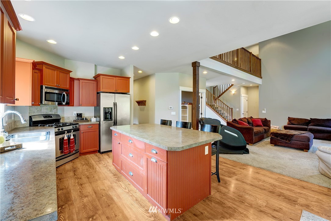 1290 West Axton Road Ferndale, WA 98248 - Photo 14 of 36 a kitchen with stainless steel appliances granite countertop a stove and a sink
