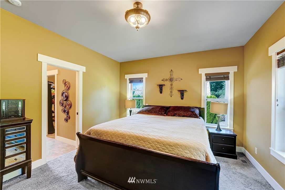 1290 West Axton Road Ferndale, WA 98248 - Photo 17 of 36 a bedroom with a bed and a dresser in it