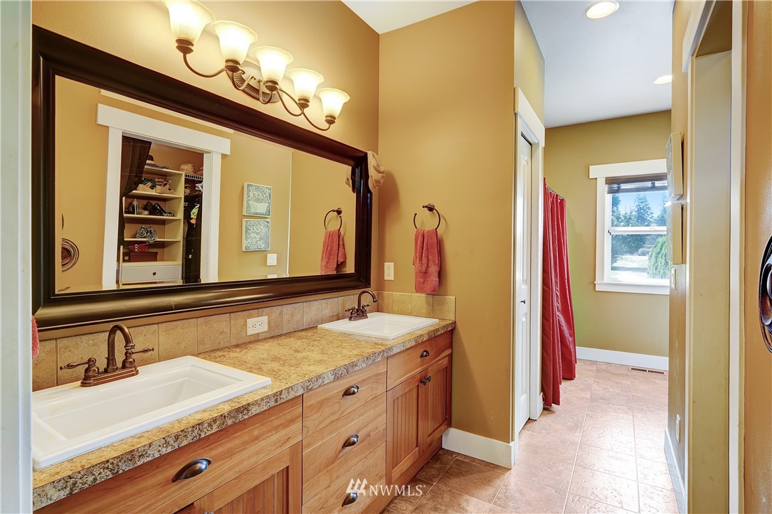 1290 West Axton Road Ferndale, WA 98248 - Photo 18 of 36 a bathroom with a granite countertop sink and a mirror