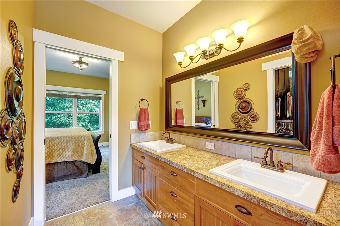 1290 West Axton Road Ferndale, WA 98248 - Photo 19 of 36 a spacious bathroom with a granite countertop sink mirror and vanity