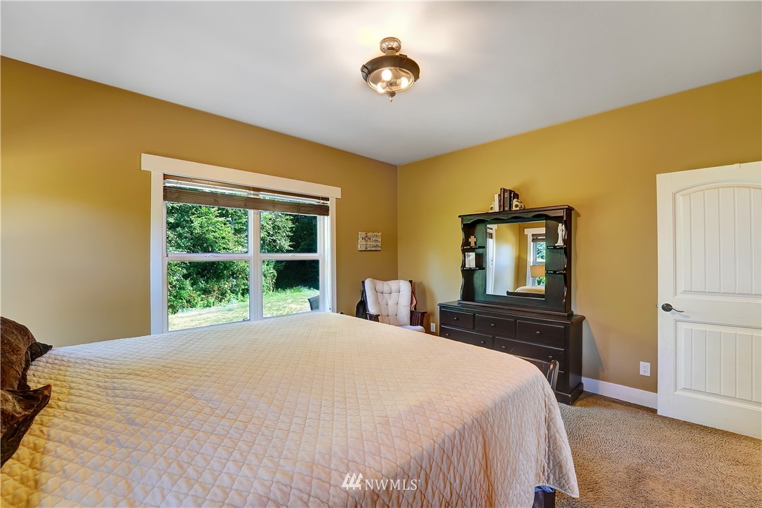 1290 West Axton Road Ferndale, WA 98248 - Photo 20 of 36 a bedroom with a bed and a window