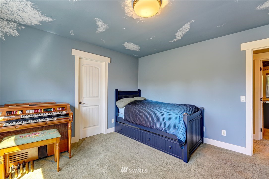 1290 West Axton Road Ferndale, WA 98248 - Photo 24 of 36 a bedroom with a bed and a dresser