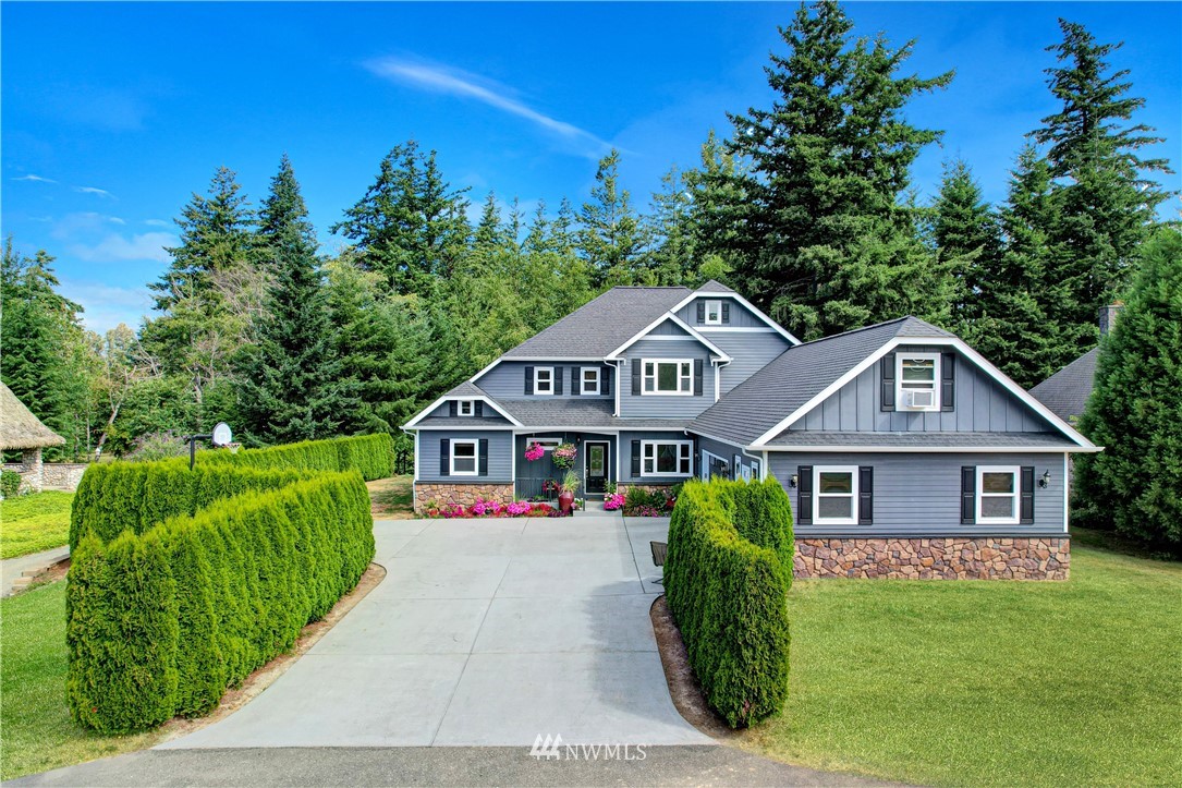 1290 West Axton Road Ferndale, WA 98248 - Photo 35 of 36 a front view of a house with a garden
