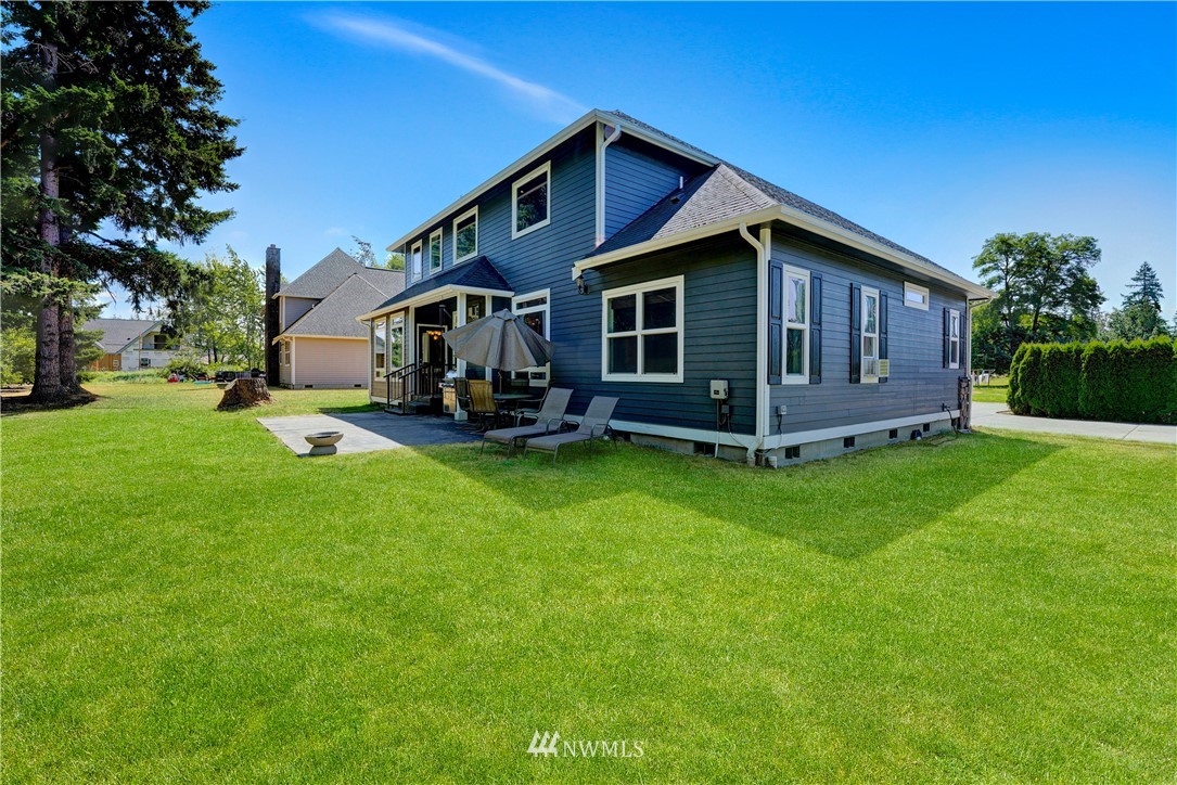 1290 West Axton Road Ferndale, WA 98248 - Photo 36 of 36 a front view of a house with garden and trees