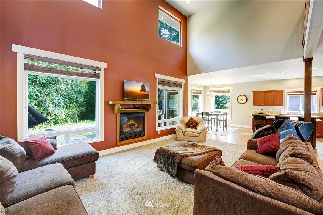 1290 West Axton Road Ferndale, WA 98248 - Photo 10 of 36 a living room with furniture a fireplace and a large window