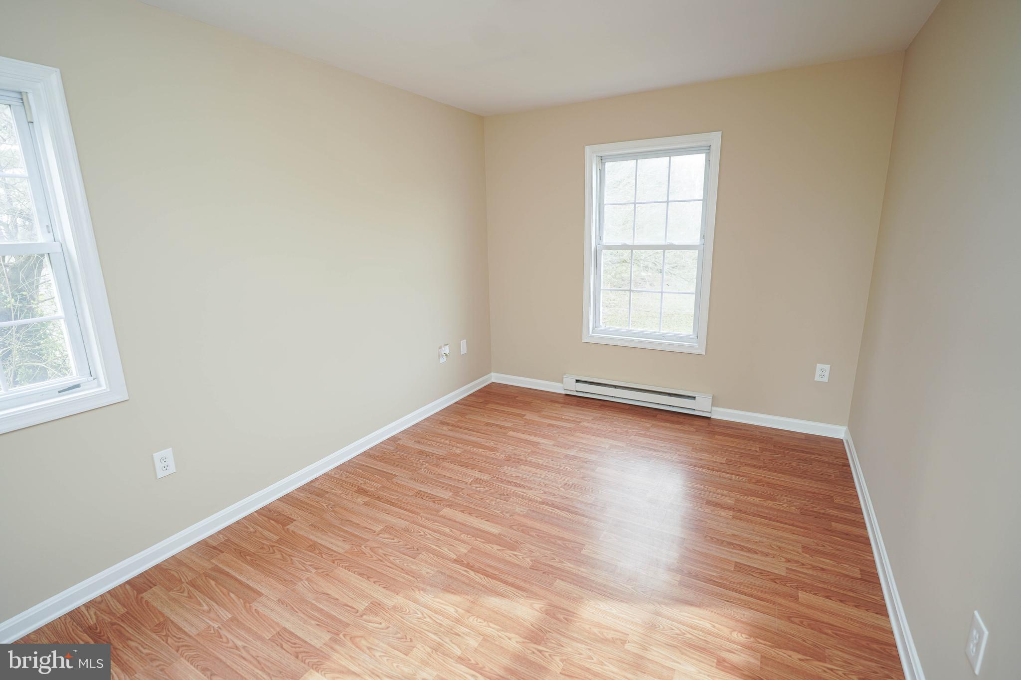 7526 Bethel Road Willards, MD 21874 - Photo 15 of 34 an empty room with wooden floor and windows