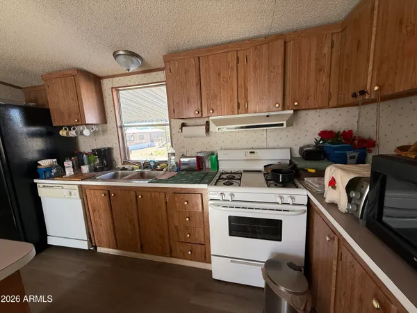 a kitchen with a white stove and white cabinets