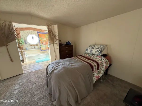 a bed sitting in a bedroom next to a window