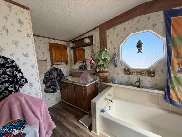 a bathroom with a tub sink and mirror