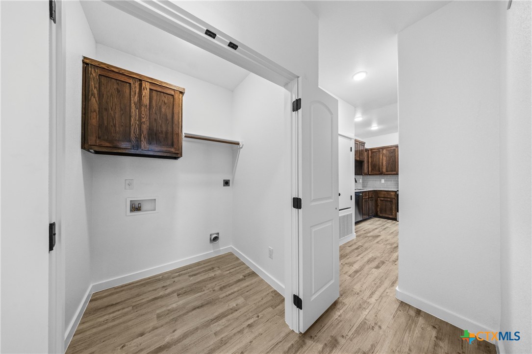 3606 Canvasback Road, Unit B Killeen, TX 76542 - Photo 14 of 19 a view of a hallway with wooden floor and staircase