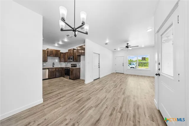 a view of a kitchen with a sink and wooden floor
