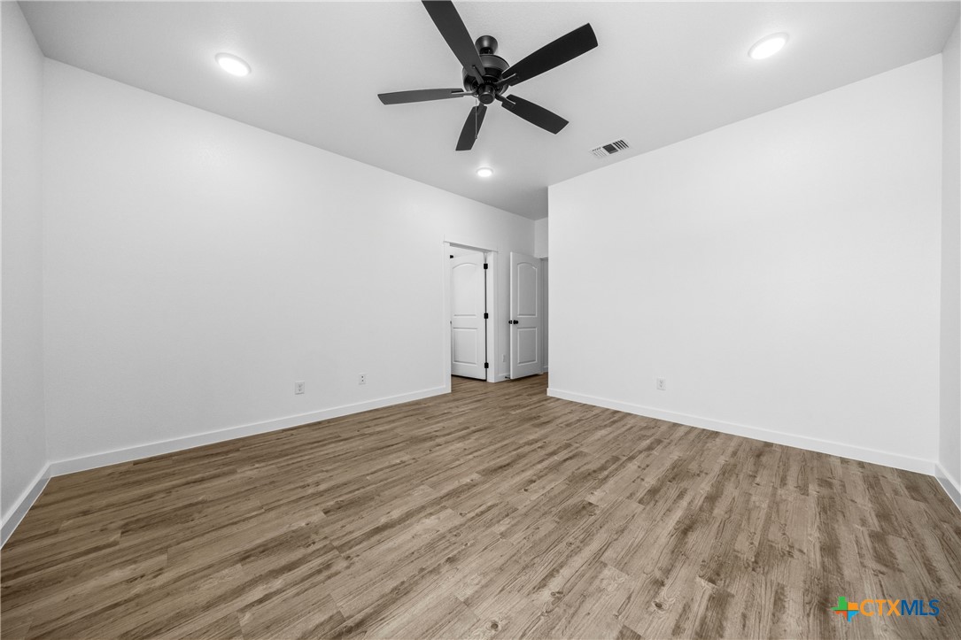 3606 Canvasback Road, Unit B Killeen, TX 76542 - Photo 6 of 19 an empty room with wooden floor and ceiling fan