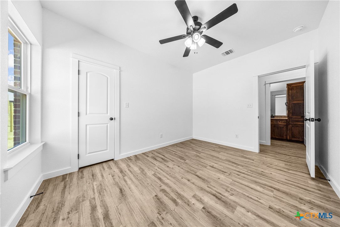3606 Canvasback Road, Unit B Killeen, TX 76542 - Photo 7 of 19 wooden floor in an empty room with a window