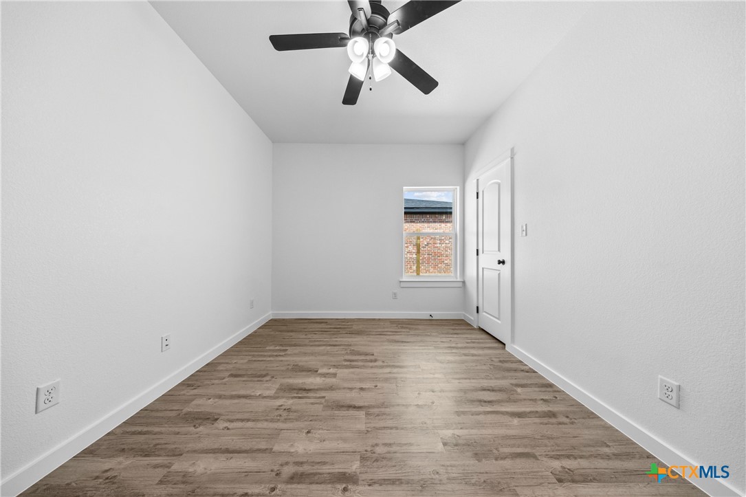 3606 Canvasback Road, Unit B Killeen, TX 76542 - Photo 9 of 19 wooden floor in an empty room with a window