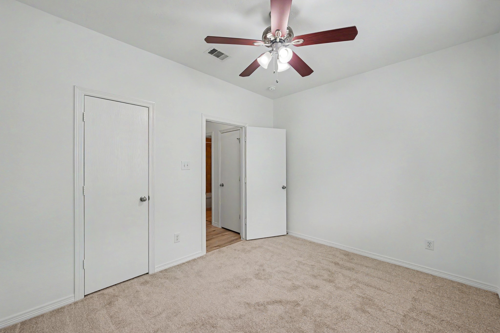 13035 Avery Ridge Lane Tomball, TX 77377 - Photo 20 of 27 Bright and inviting guest bedroom #2 featuring new carpeting, a ceiling fan for comfort, and neutral walls ready for your personal touch.