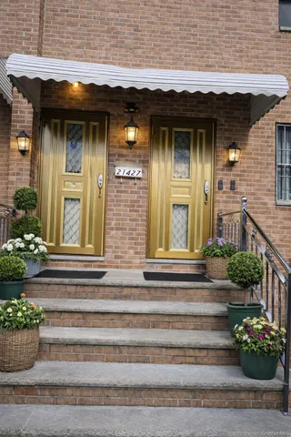 a front view of a house with potted plants