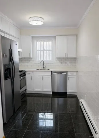 a kitchen with stainless steel appliances granite countertop a sink a stove a refrigerator and island