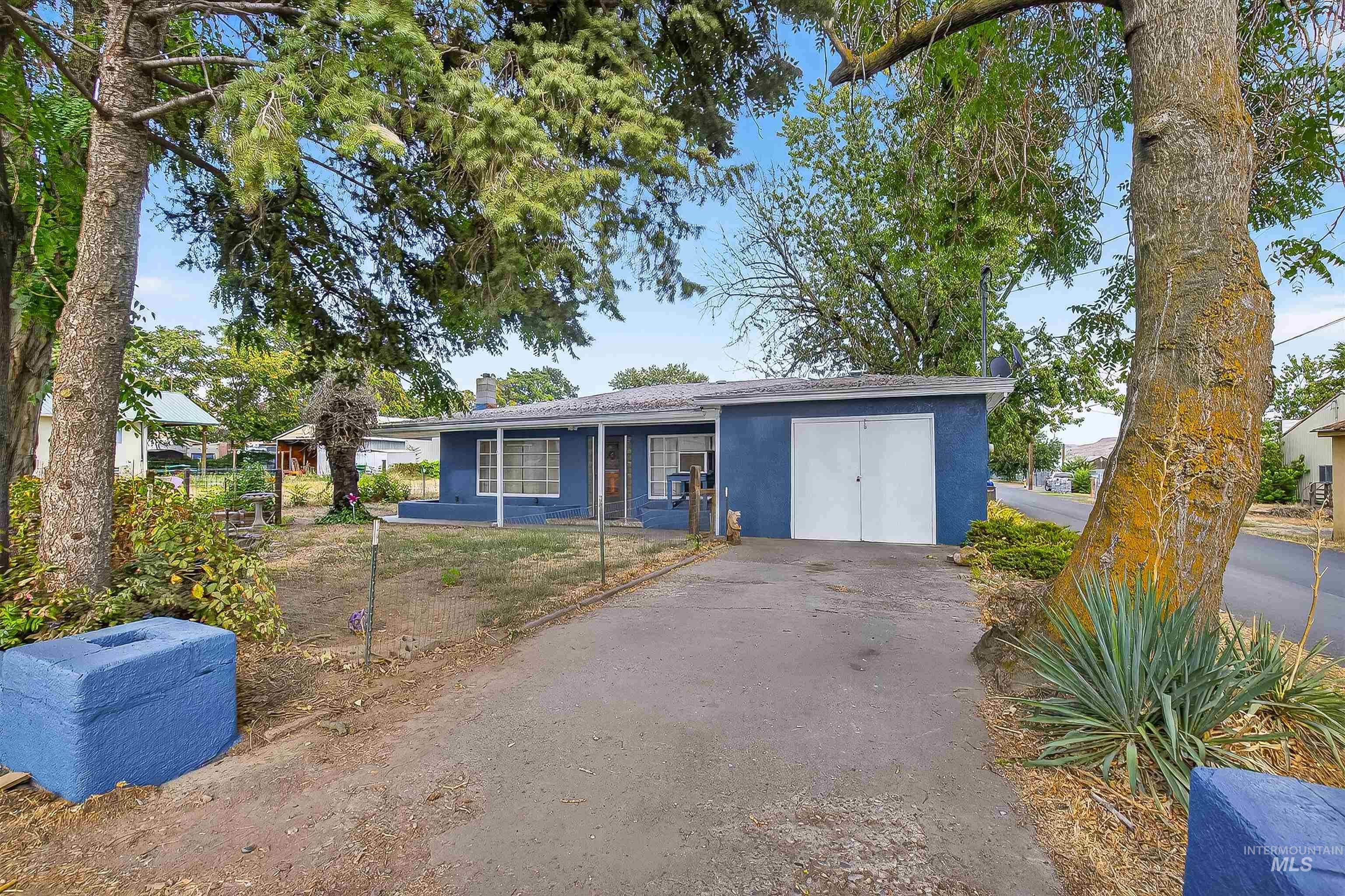 Ranch-style house with stucco siding and a chimney