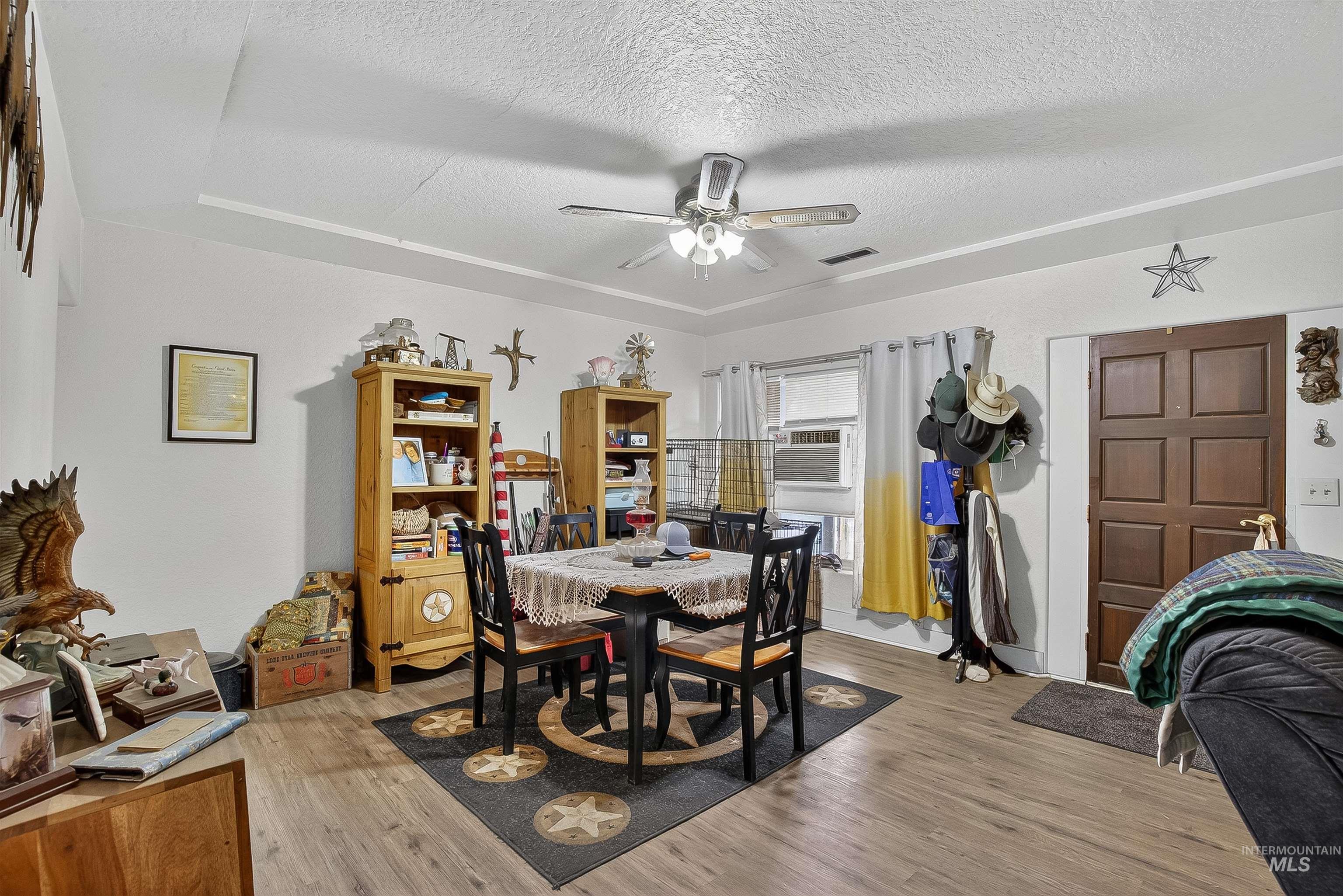 705 28th Street North Lewiston, ID 83501 - Photo 8 of 34 Dining room featuring light wood finished floors, a textured ceiling, ceiling fan, and cooling unit