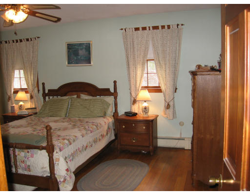 105 Rockwood Road Norfolk, MA 02056 - Photo 7 of 8 a bedroom with a bed and wooden floor