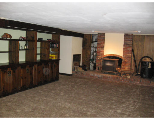105 Rockwood Road Norfolk, MA 02056 - Photo 8 of 8 a living room with furniture a fireplace and gym equipment