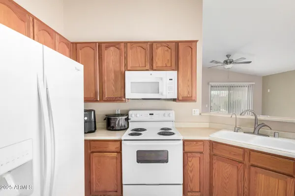 a kitchen with a refrigerator a stove a sink and a cabinets