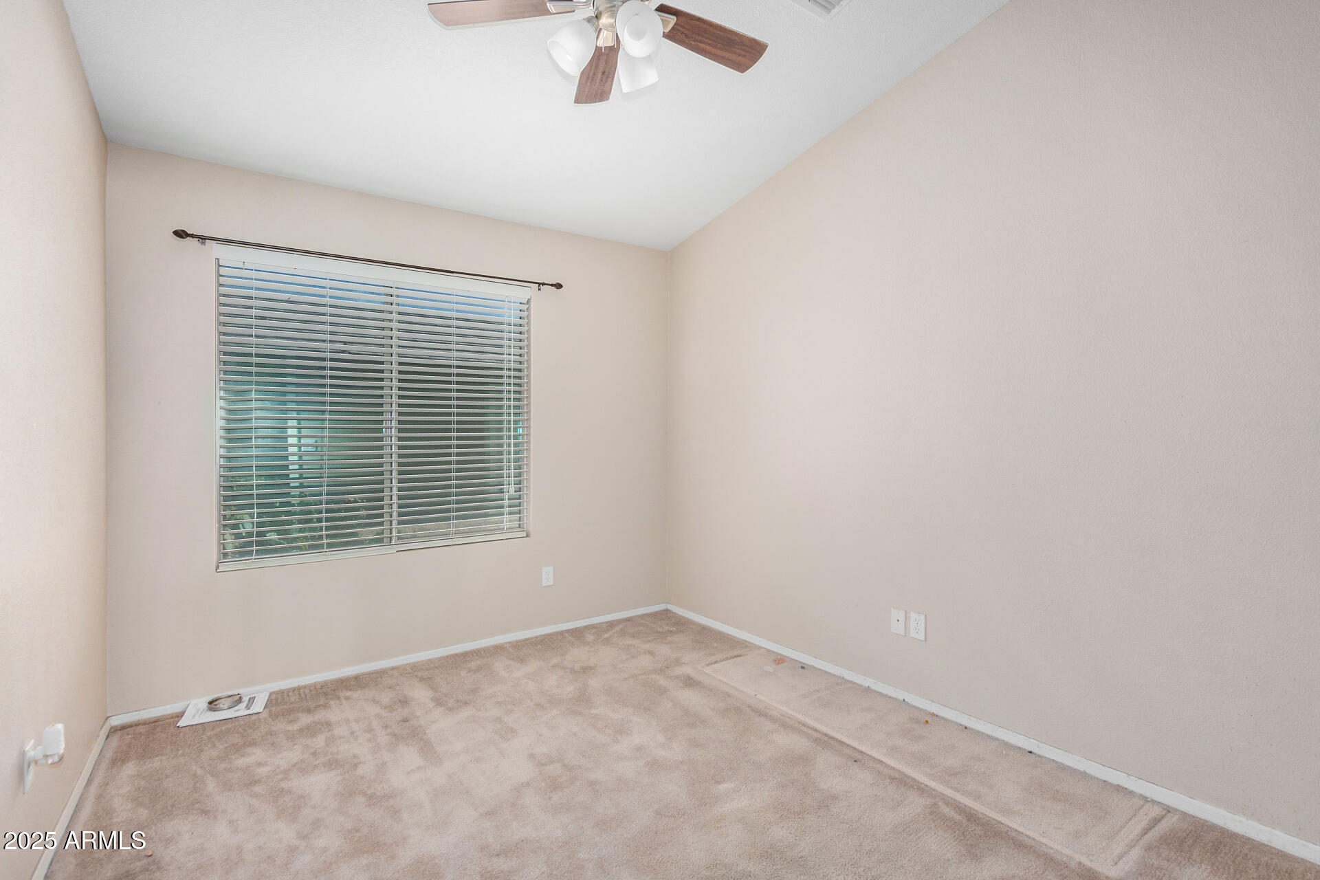 2101 South Meridian Road, Unit 403 Apache Junction, AZ 85120 - Photo 16 of 24 an empty room with a window and a ceiling fan
