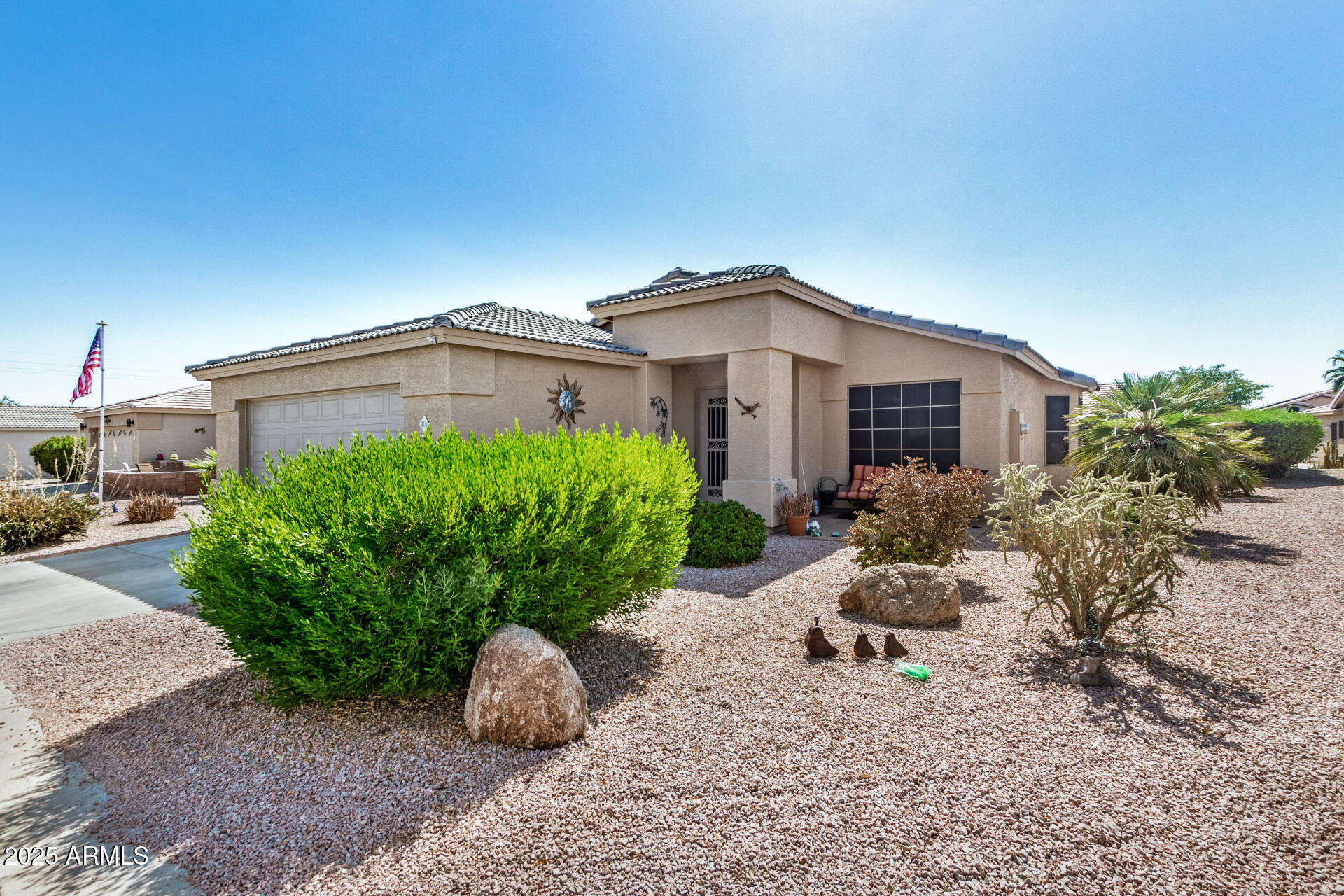 2101 South Meridian Road, Unit 403 Apache Junction, AZ 85120 - Photo 2 of 24 a front view of a house with garden