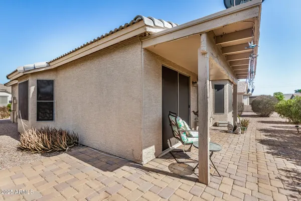 a front view of a house with sitting area