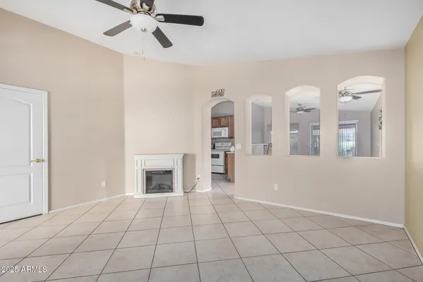 a view of an empty room with window and fireplace