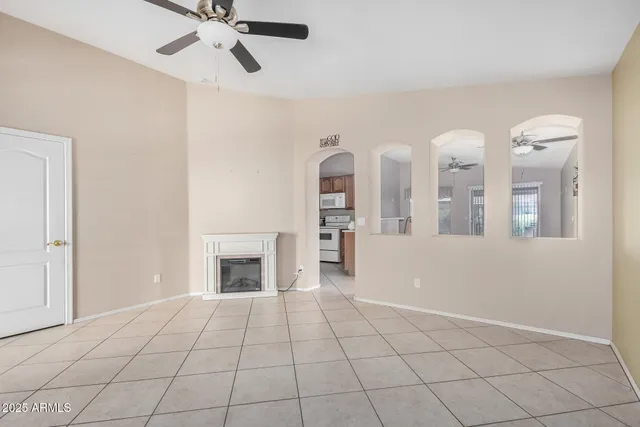 a view of an empty room with window and fireplace