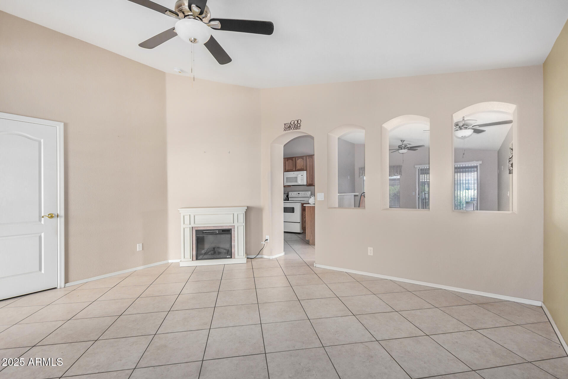 2101 South Meridian Road, Unit 403 Apache Junction, AZ 85120 - Photo 5 of 24 a view of an empty room with window and fireplace