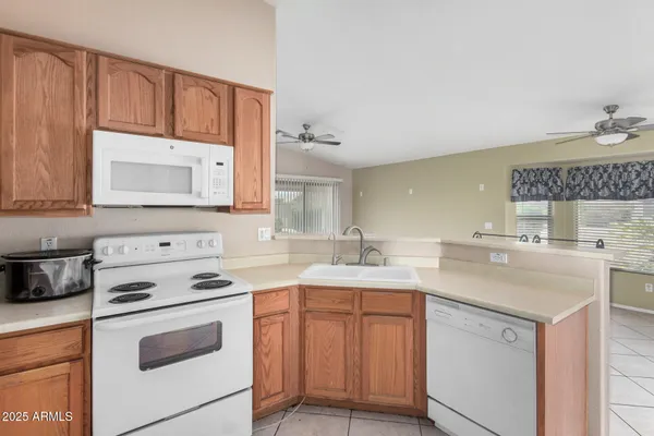 a kitchen with a sink stove top oven and cabinets