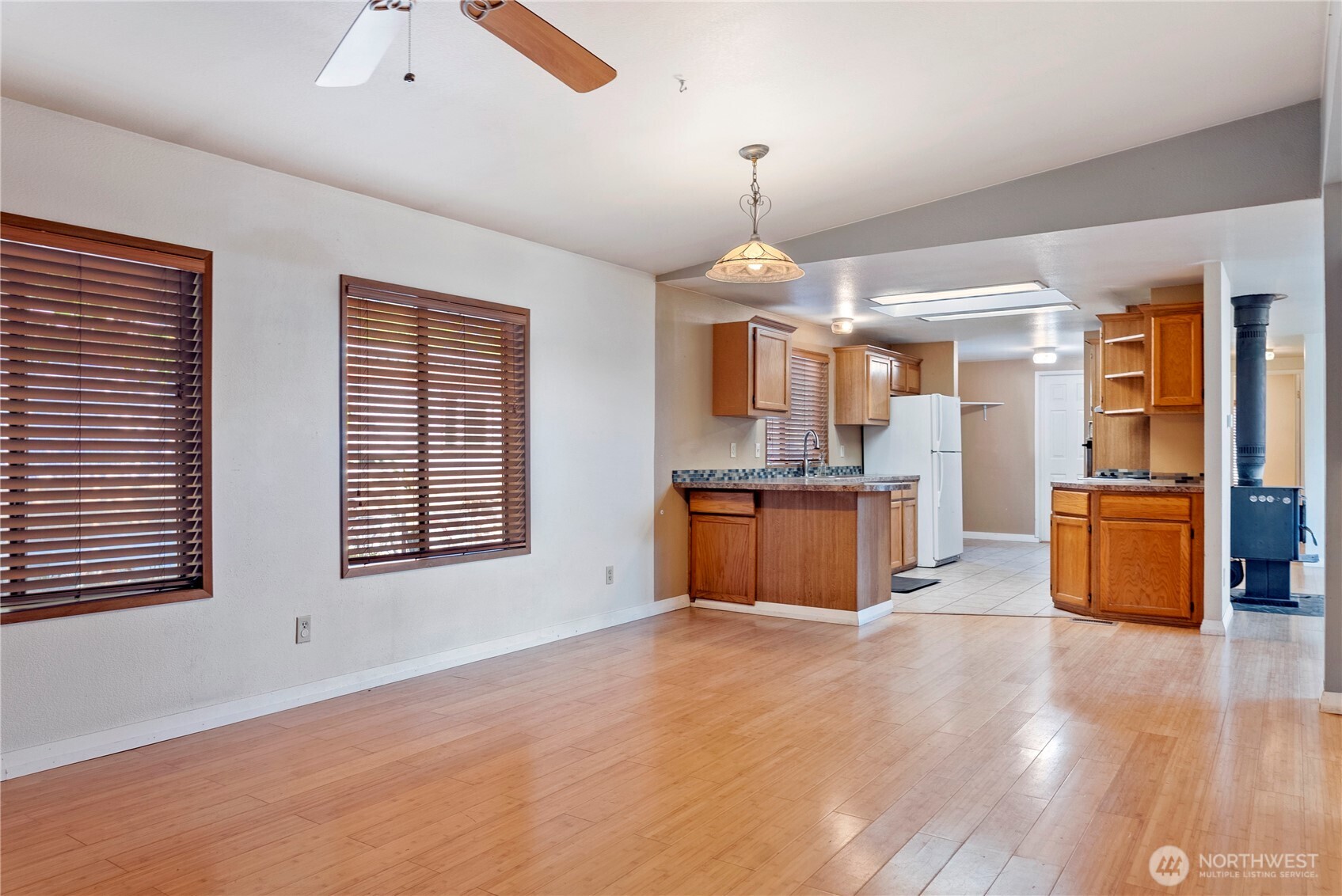 1221 Riverside Avenue Twisp, WA 98856 - Photo 15 of 40 a kitchen with stainless steel appliances kitchen island granite countertop a refrigerator and a sink