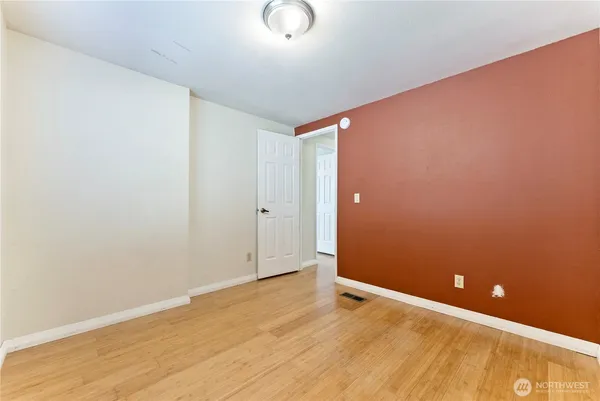 a view of livingroom with hardwood floor and a bathroom