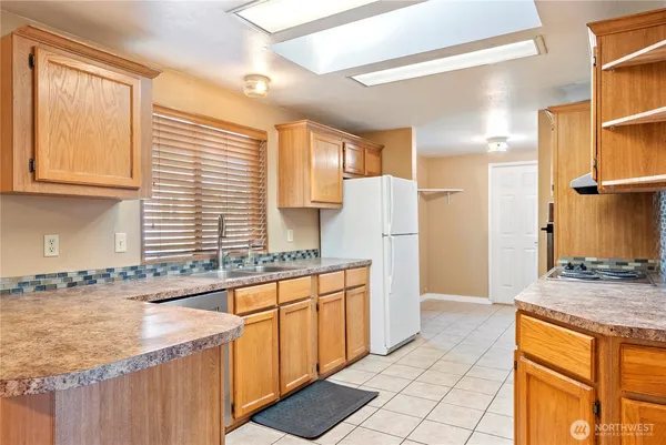 a kitchen with stainless steel appliances granite countertop a sink and a stove