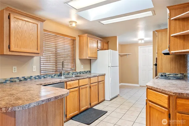 a kitchen with stainless steel appliances granite countertop a sink and a stove