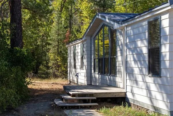 a backyard of a house with barbeque oven and outdoor seating