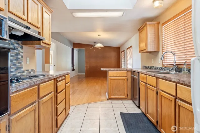 a view of a livingroom with a kitchen and a window