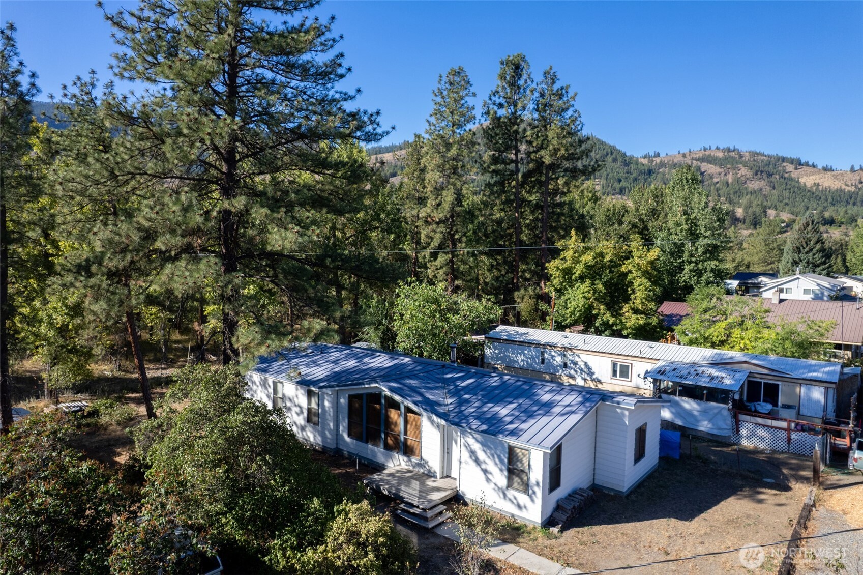 1221 Riverside Avenue Twisp, WA 98856 - Photo 3 of 40 a view of an outdoor sitting area with brick wall