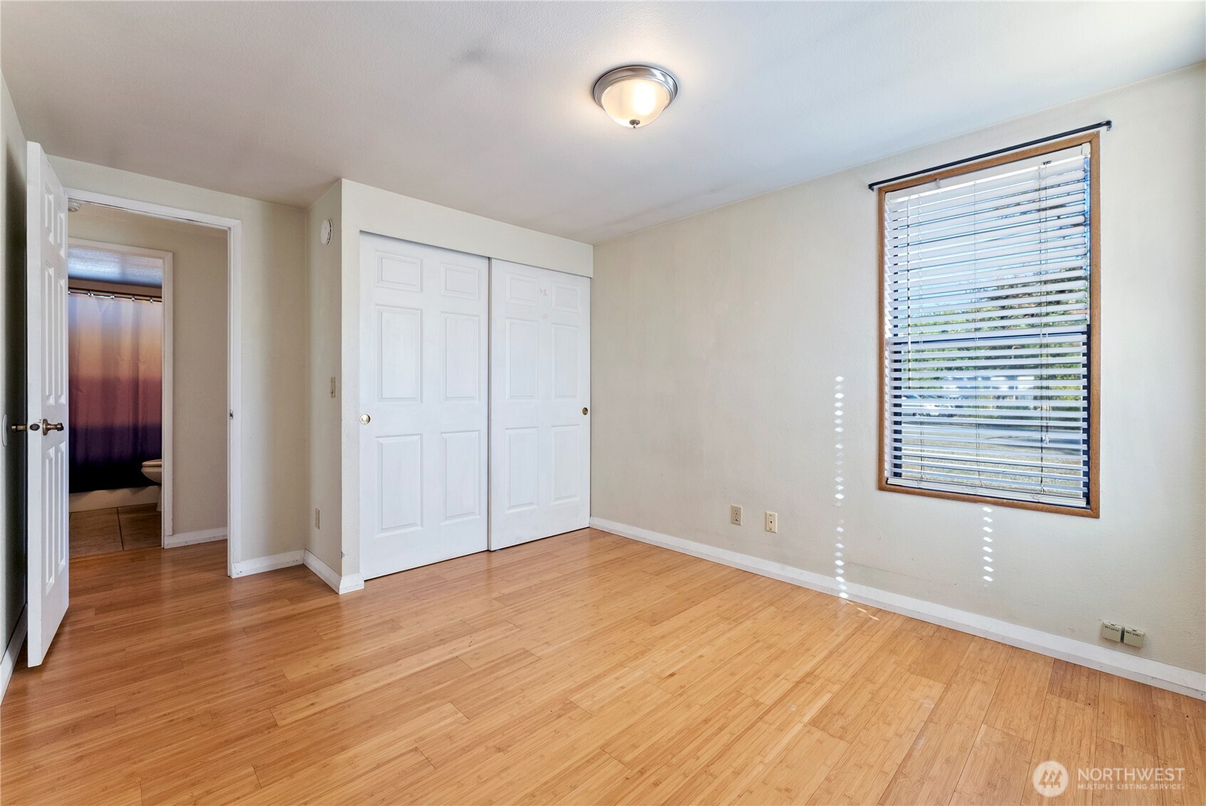 1221 Riverside Avenue Twisp, WA 98856 - Photo 36 of 40 an empty room with wooden floor and windows
