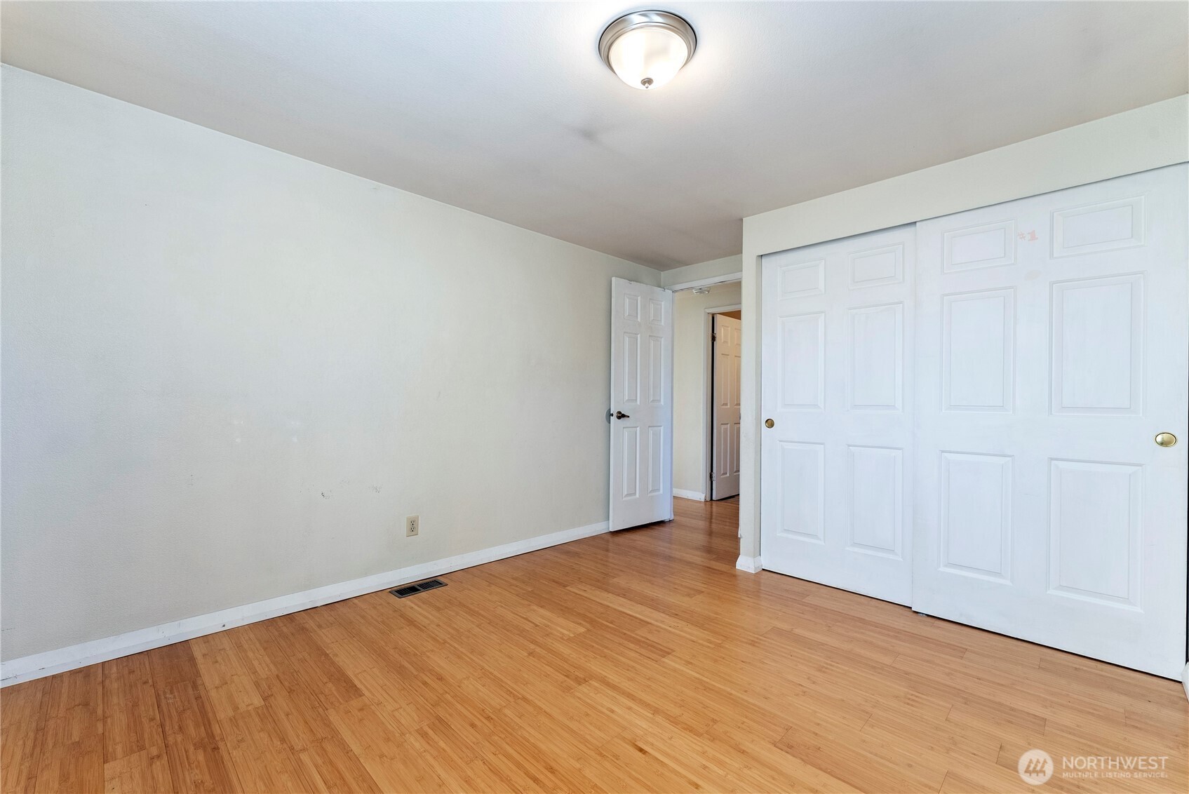 1221 Riverside Avenue Twisp, WA 98856 - Photo 38 of 40 an empty room with wooden floor and windows