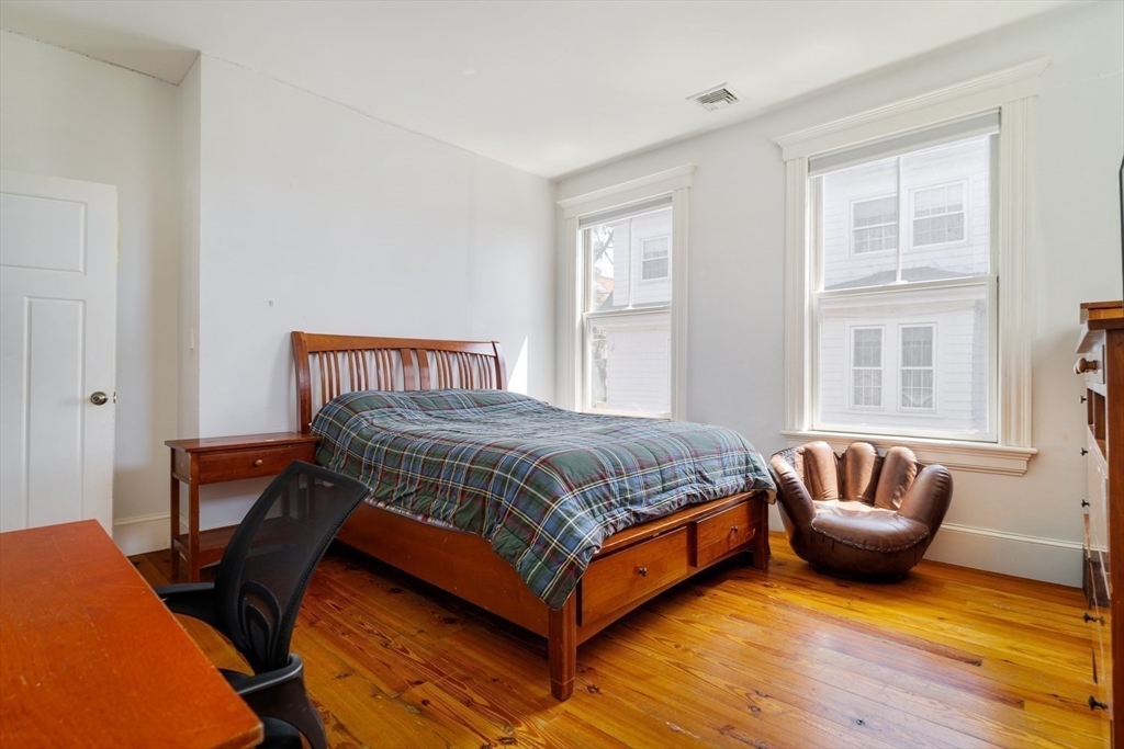 70 Oxford Street Somerville, MA 02143 - Photo 21 of 38 a bedroom with a bed and a window