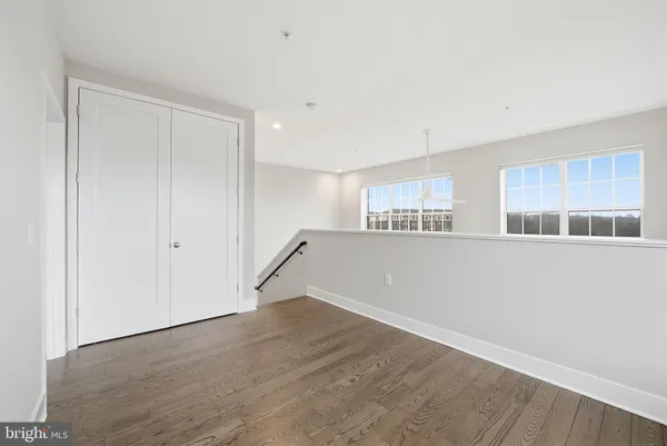 a view of empty room with wooden floor and cabinet