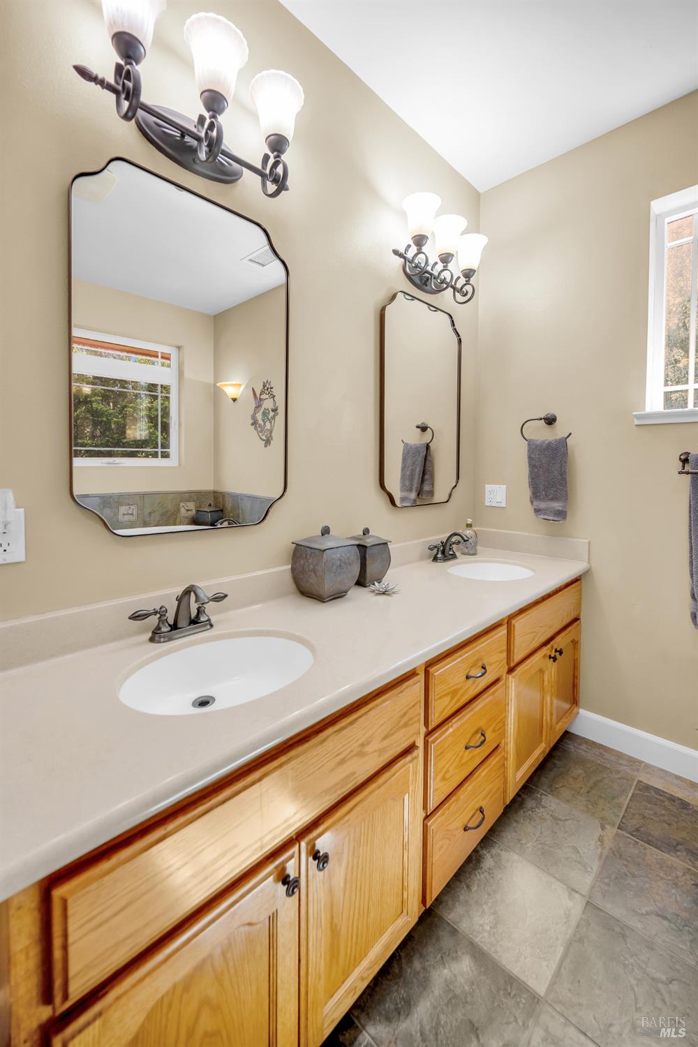 3970 Canyon Road Willits, CA 95490 - Photo 20 of 67 a bathroom with double vanity sinks and a mirror