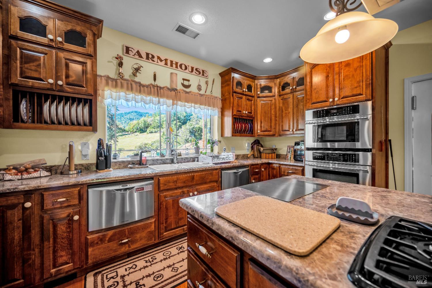3970 Canyon Road Willits, CA 95490 - Photo 55 of 67 a kitchen with stainless steel appliances granite countertop a stove and cabinets