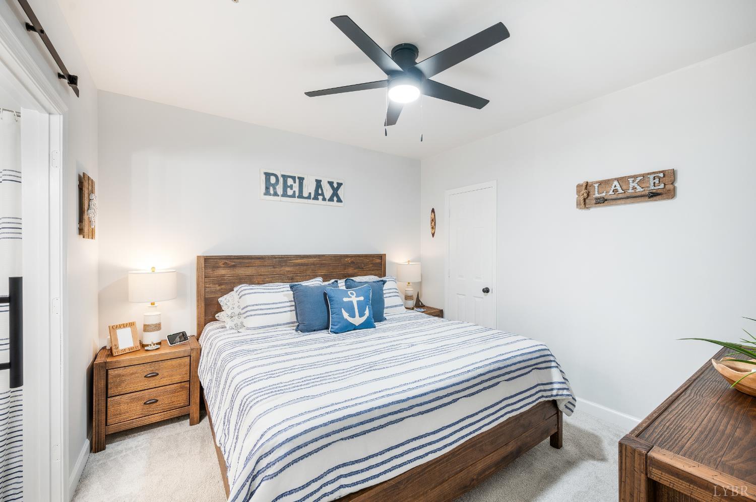 1245 Graves Harbor Trail, Unit 212 Huddleston, VA 24104 - Photo 11 of 60 a bedroom with a bed and a ceiling fan