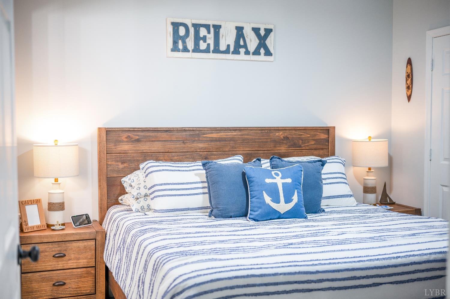 1245 Graves Harbor Trail, Unit 212 Huddleston, VA 24104 - Photo 12 of 60 a bedroom with a bed and wooden floor