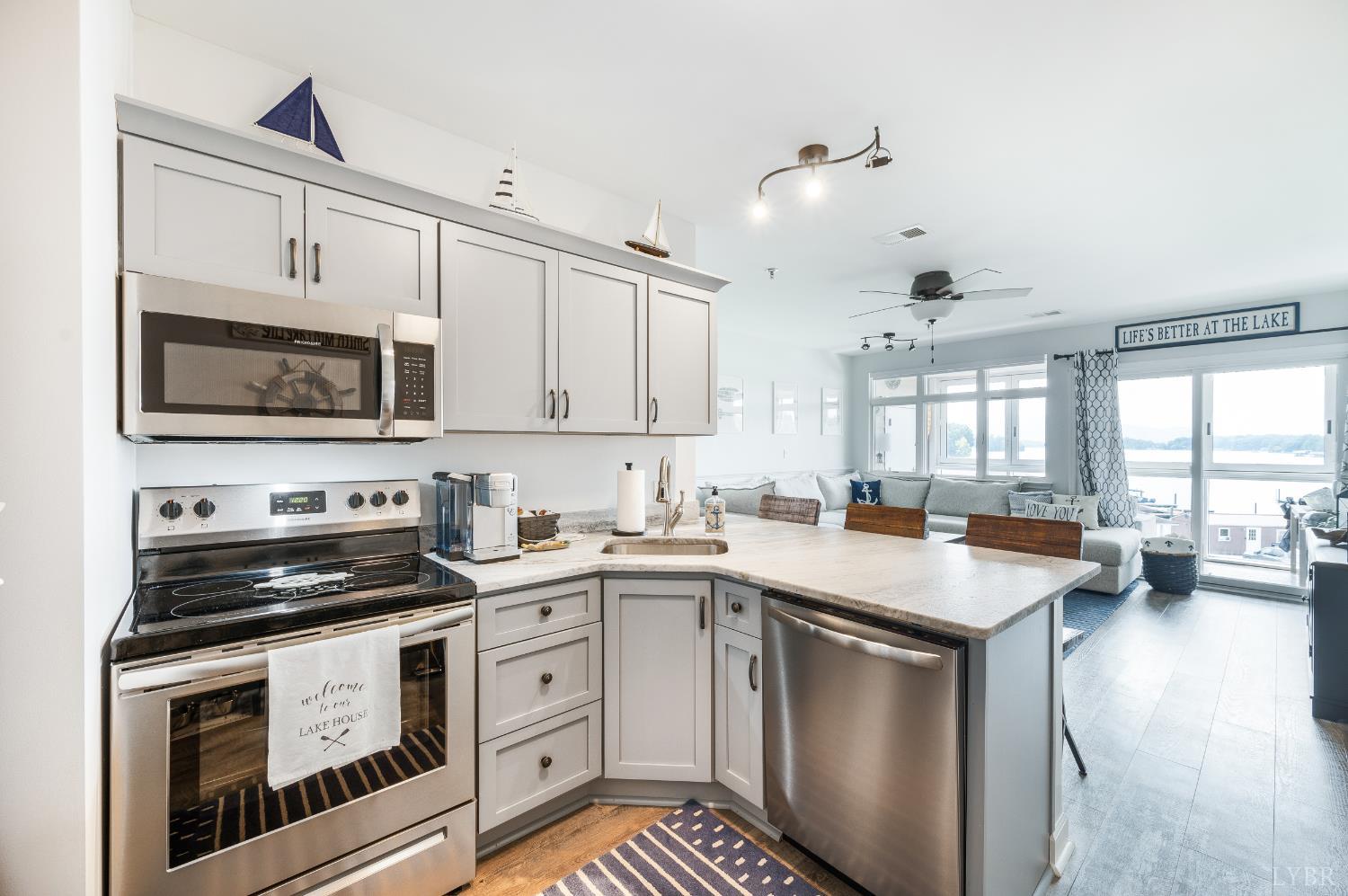 1245 Graves Harbor Trail, Unit 212 Huddleston, VA 24104 - Photo 19 of 60 a kitchen with stainless steel appliances a stove a sink a stove and white cabinets